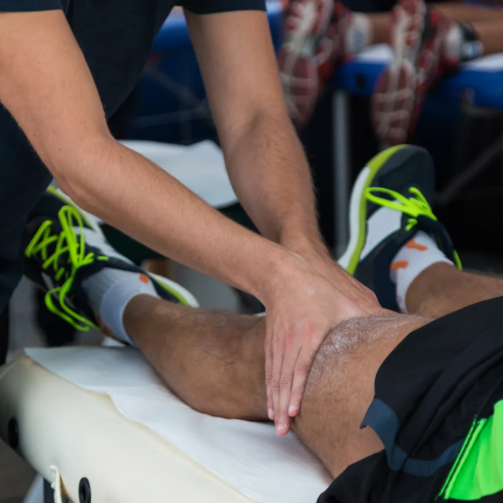 man receiving leg massage on treatment table